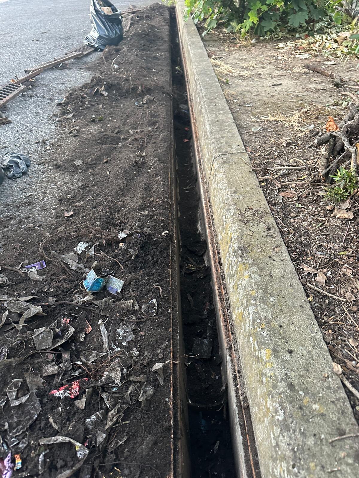Linear drain cleared of silt and debris